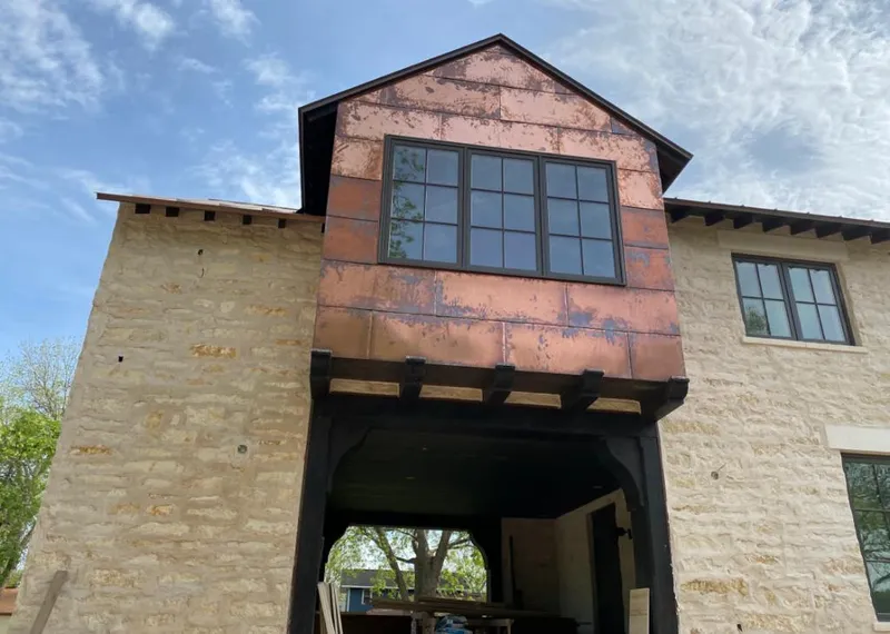 Copper metal panel facade on a stone building for Skylight Installation in Schererville