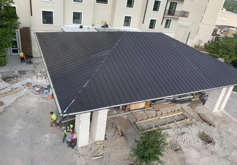 Metal roofing installation team working on a commercial building in Schererville